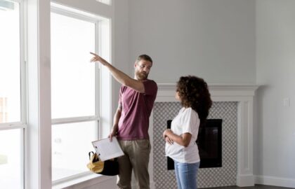 Home Inspector Points to Something Outside The Window