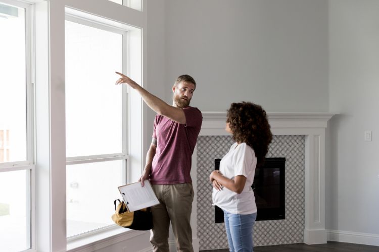 Home Inspector Points to Something Outside The Window